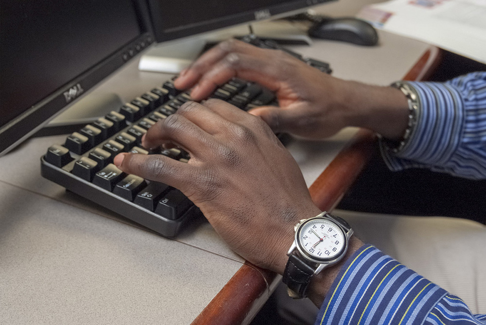 Student typing on a keyboard