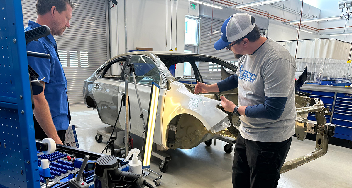 Winferd Vermillion (left), a Collision Technology student, receives training from Christopher Allen of PDR Express. Photo by Raven Hartkopf, Collin College discipline lead and professor of Collision Technology.